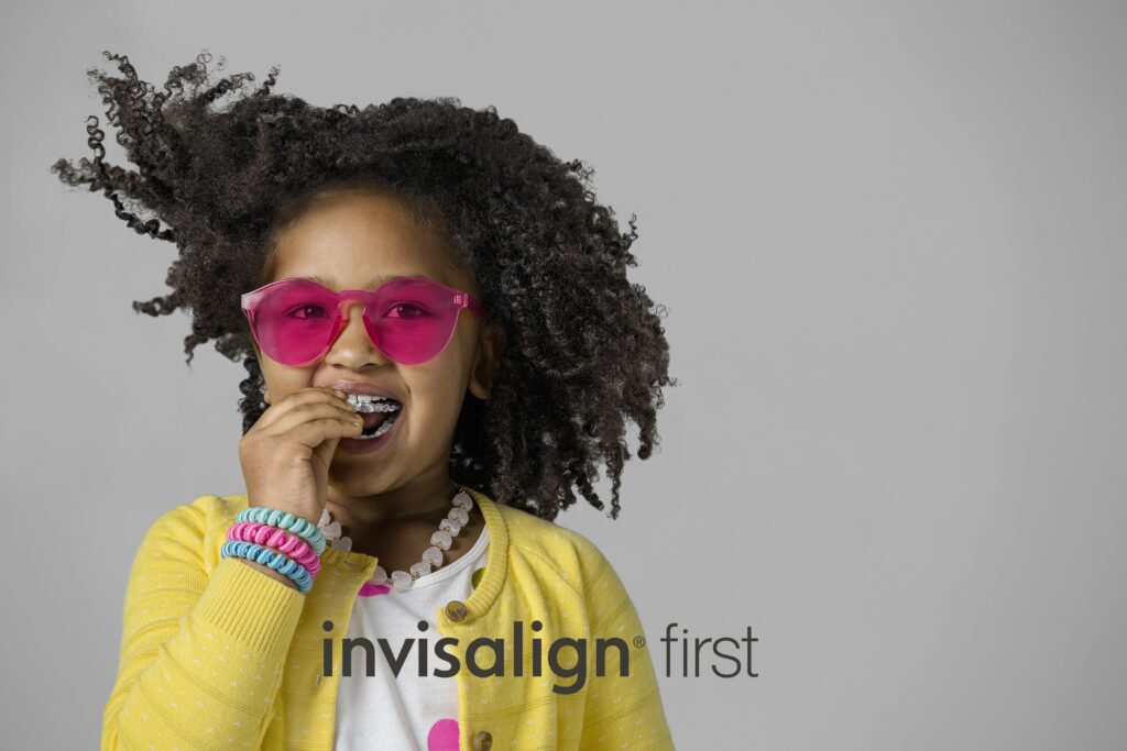 Child putting in clear aligners